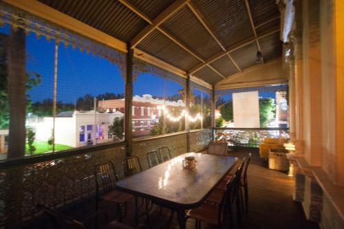 a table and chairs on a balcony with a view at Treehouse Hideouts Balcony Apartment - Port of Echuca Townhouse in Echuca