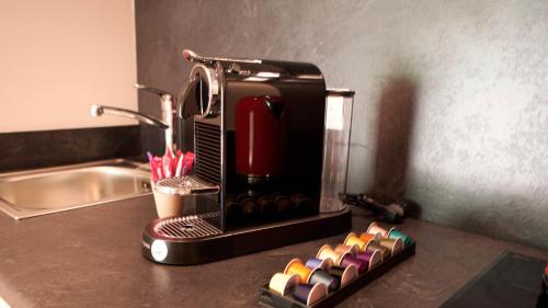 a coffee maker sitting on a counter next to a sink at Les Pins de l'Escalet in Ramatuelle