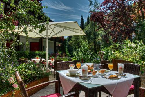 a table with food and drinks on a patio at DIANA Naturpark Hotel - Partnerbetrieb von "Oberstaufen PLUS GOLF" in Oberstaufen