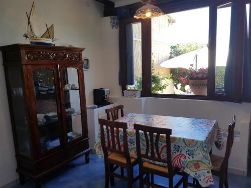 a dining room with a table and chairs and a cabinet at Stromboli Vacanze in Stromboli