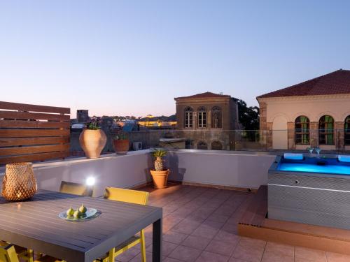 a rooftop patio with a table and a sink at Mediterraneo Suite Home in Rethymno