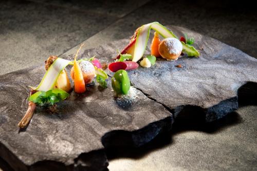 a group of fruits and vegetables on a rock at Hotel Schachner in Maria Taferl