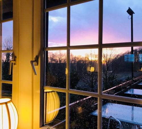 a window with a view of a train seen through it at Hotel Niedersächsischer Hof in Bad Bentheim