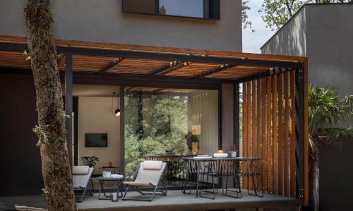an outdoor patio with a table and chairs at Aminess Younique Gaia Green Villas in Njivice