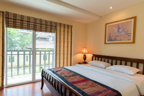 a bedroom with a bed and a large window at Jomtien Beach Residence in Jomtien Beach