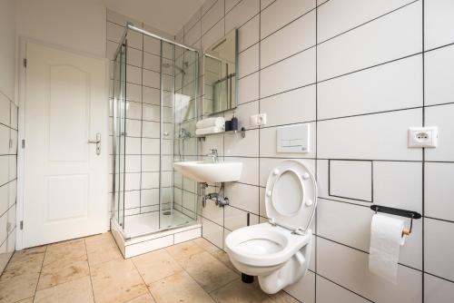 a bathroom with a toilet and a sink at Apart-Hostel ZERO in Bratislava