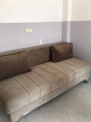 a brown couch sitting in a room at Apartments Flamida in Ulcinj