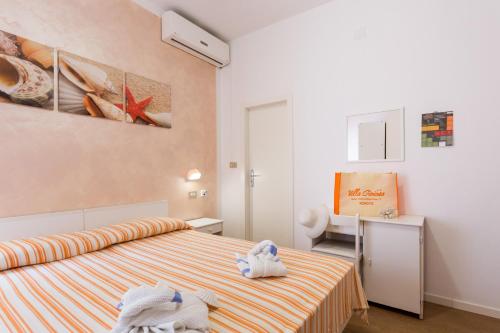 Säng eller sängar i ett rum på Hotel Villa Gioiosa