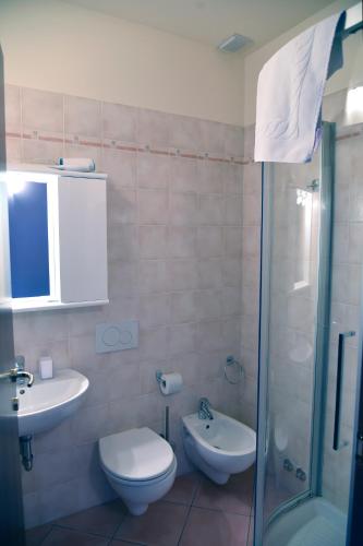 a bathroom with a toilet and a sink and a shower at Agriturismo Argaland in Parma