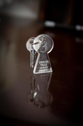 a key chain on top of a table at Tenuta Villa Colle Sereno in Montemarciano