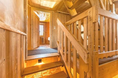 a wooden staircase in a house with wooden walls at Ferienhäuser Tschofen Garfrescha in Sankt Gallenkirch