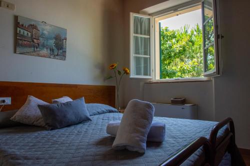 a bedroom with a bed with pillows and a window at Tenuta Villa Colle Sereno in Montemarciano