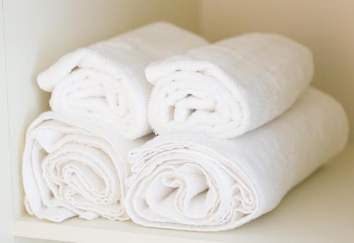 a stack of white towels on a shelf at Newcastle Court in Galway
