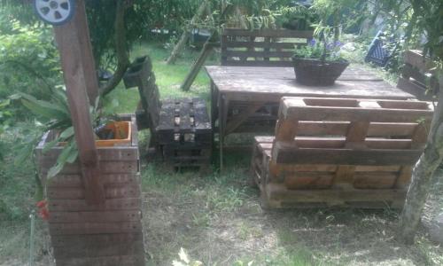 a wooden table and chairs in a yard with a table at Vila Hipo in Venus