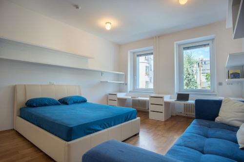 a bedroom with two beds and a couch at Luxury Central Apartment in Ljubljana