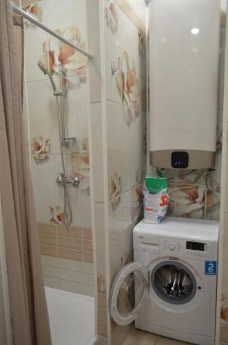 a washing machine in a bathroom with a shower at Hostel Energia in Kazan