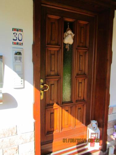 a wooden door with a stairway leading up to it at Ciesa Dei Maestri in Sottoguda