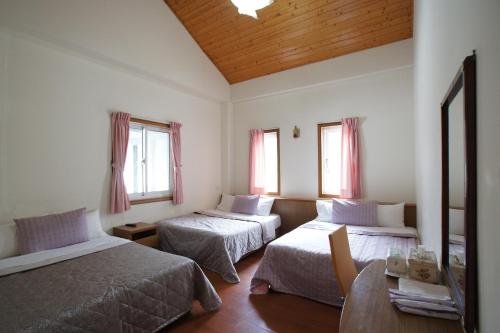 Postel nebo postele na pokoji v ubytování Music House Homestay