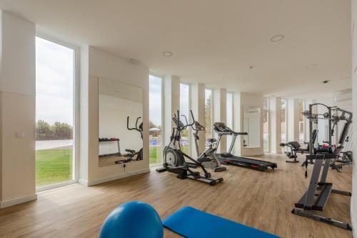 a gym with treadmills and elliptical machines at Luna Hotel Turismo in Abrantes