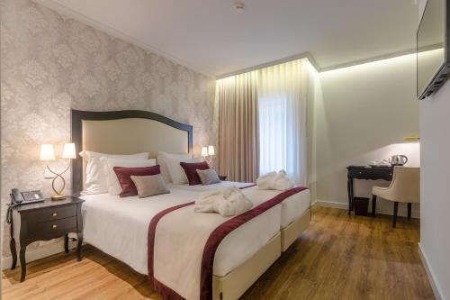Säng eller sängar i ett rum på Luna Hotel Turismo