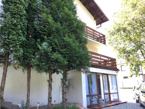 a building with trees in front of it at Olimpijska pokoje in Szczyrk
