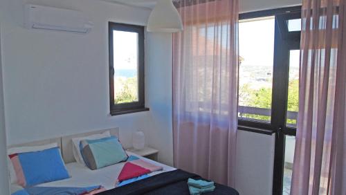 a bedroom with a bed and a window with a view at Villa Burkopolis in Sozopol