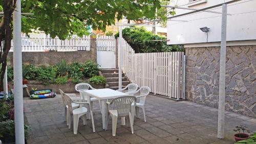 a white table and chairs on a patio at Villa Burkopolis in Sozopol
