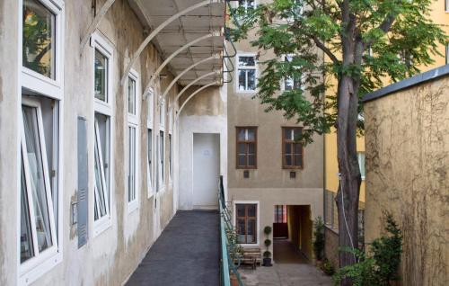 an empty hallway in a building with a tree at Metro Apartments Vienna in Vienna