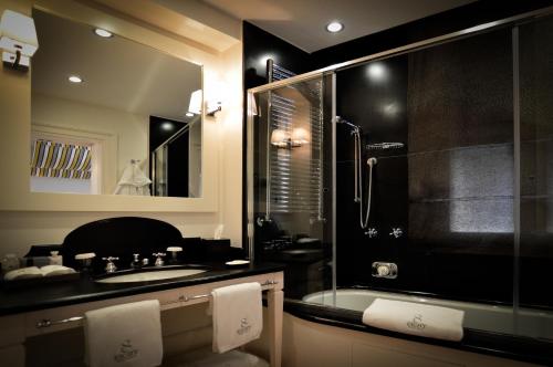 a bathroom with a tub and a sink and a shower at Eight Hotel Portofino in Portofino