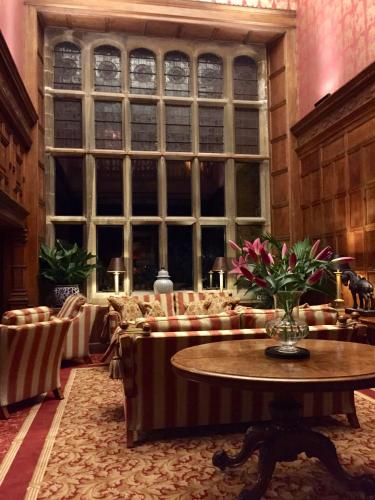a room with a table and chairs and a large window at The Wrea Head Hall Country House Hotel & Restaurant in Scarborough