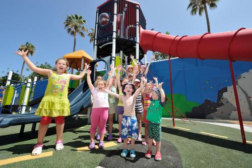 a group of children standing in front of a slide at Spring Hotel Bitácora in Playa de las Americas