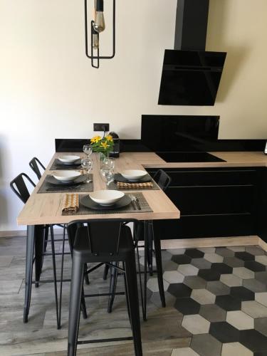 a kitchen with a table with chairs and a stove at CasaCosy in Les Michels