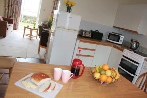 A kitchen or kitchenette at Giant's Causeway Holiday Cottages 