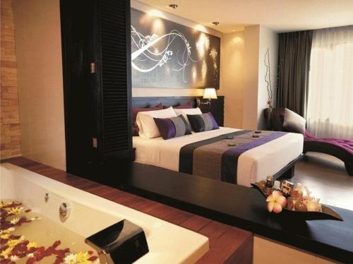 Postel nebo postele na pokoji v ubytování Nouvo City Hotel