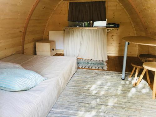a bedroom with a bed and a table in a room at Camping Oleiros in Oleiros