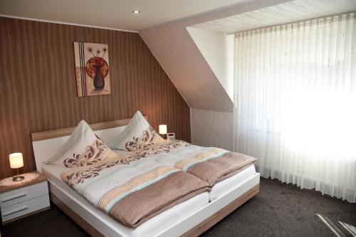 a bedroom with a large bed and a window at Pension Heib in Cochem