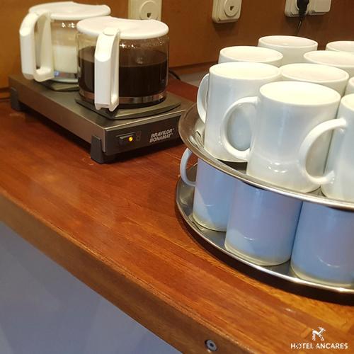 a counter with white cups and a coffee maker at Ancares in Balboa