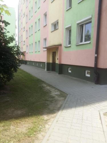 a row of colorful buildings in a city at Apartament Czwarte Piętro in Świecie