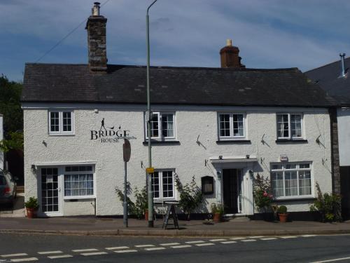 a white building on the corner of a street at Bridge House in Bampton