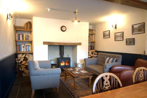 a living room with a couch and a fire place at Bridge House in Bampton
