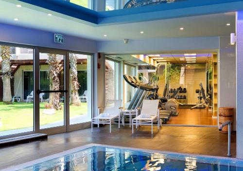 a house with a swimming pool and a gym at Luxury Sea View Apartment in Herzelia 