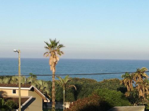 a view of the ocean from the balcony of a house at A Wave from it all in Port Shepstone