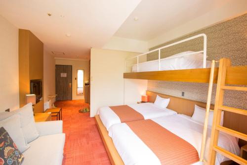 Ένα ή περισσότερα κρεβάτια σε δωμάτιο στο Kirishima Kanko Hotel