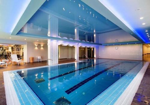 a large swimming pool in a hotel room with at Luxury Sea View Apartment in Herzelia 