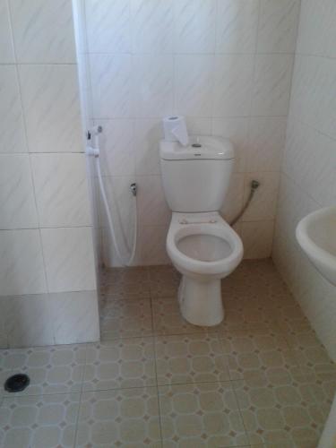 a bathroom with a toilet and a sink at JJ & JE Family House in Dar es Salaam