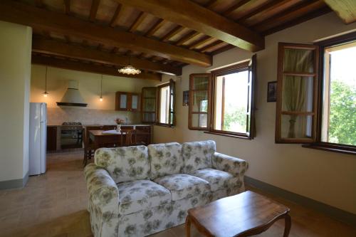 a living room with a couch and a table at Agriturismo Il Beccafico Alpaca in Mengara