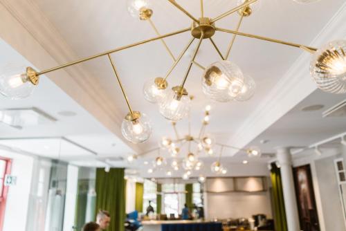 a group of lights hanging from a ceiling at Park Hotel Viljandi in Viljandi