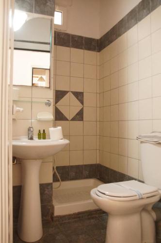 a bathroom with a toilet and a sink at Αnna in Loutro