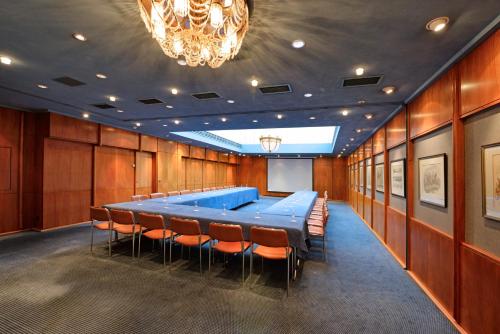 a conference room with a large blue table and chairs at Hotel Sonne Eintracht KG Achern in Achern