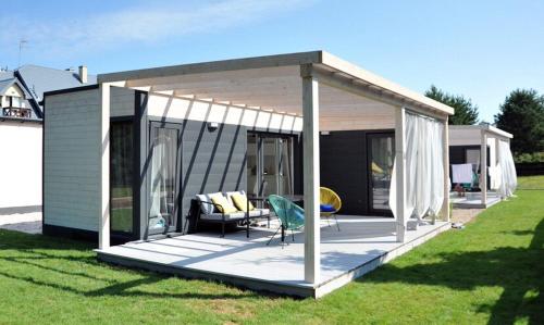 een paviljoen met een terras in een tuin bij Art Apartments in Odargowo